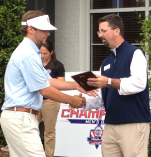Courtesy+of%3A+GSU+athleticsThe+Georgia+Southern+University+golf+team+claimed+fifth+place+at+the+SoCon+tournament.+Left%3A+Sophomore+Scott+Wolfes+accepts+the+SoCon+Golfer+of+the+Year+plaque.+Wolfes+averaged+71.50+strokes+per+round.+Right%3A+Sophomore+Charlie+Martin+watches+his+shot.+Martin+averages+74.27+strokes+per+round.