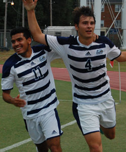 Sophomore defender Reed Norton (4) celebrates with junior midfielder David Vargas Masis (11) after Norton records a goal against Presbyterian College.Photo by: Christal Riley