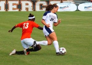 Sophomore defender Jessie Eberhardt (21) steals the ball from junior forward Washida Blackman (13). The Eagles have the opportunity to leap up the conference standings with a victory against Elon University.Photo by: Ryan Woodham