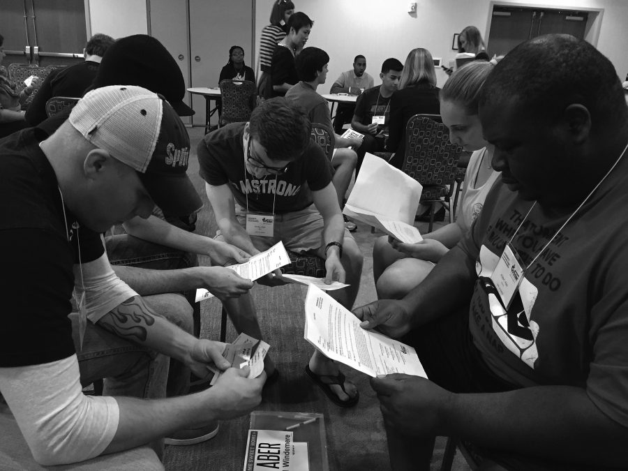 Group fills out paperwork at the poverty simulation