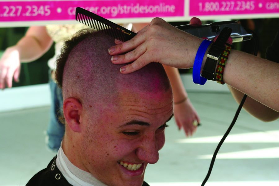 Zack Young, a sophomore rehab science major, gets his head shaved for the cause.