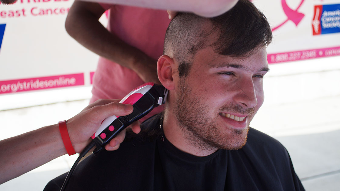 AJ Walker, sophomore, having his head shaved during the shave to save event outside of the Student Union Wednesday October 28, 2015 web