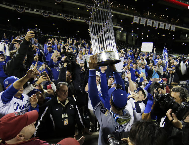 Kansas City Royals Jarrod Dyson holds the World Series trophy after Game 5 of the Major League Baseball World Series against the New York Mets Monday, Nov. 2, 2015, in New York. The Royals won 7-2 to win the series. (AP Photo/Matt Slocum)