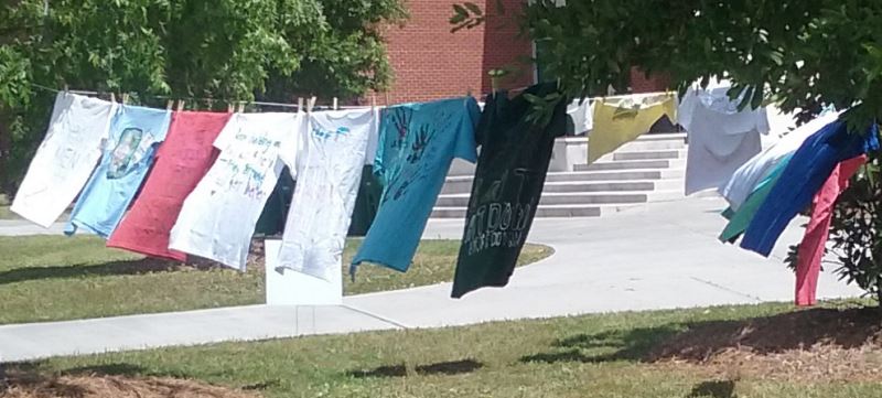 Shirts decorated by students hang on a clothesline near the student union at Alpha Kappa Alpha sorority Inc.’s event - Thursday April 21, 2016 (Photo by Emily Smith