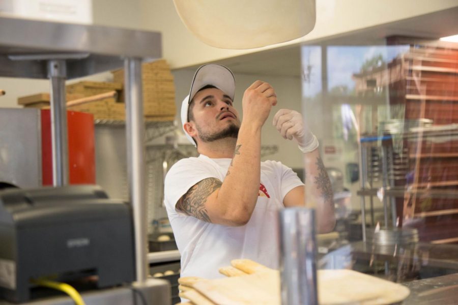 Tejeda tosses a pizza dough up in the air as it’s getting prepared. Although he wasn’t passionate about pizza before, he quickly became passionate about pizza’s and enjoys cooking them.