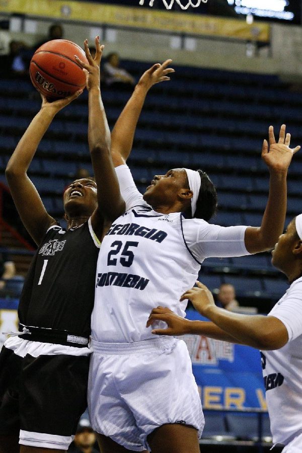 GS senior Sierra Butler goes up for a block last season. She scored 16 points in the GS exhibition win on Halloween.