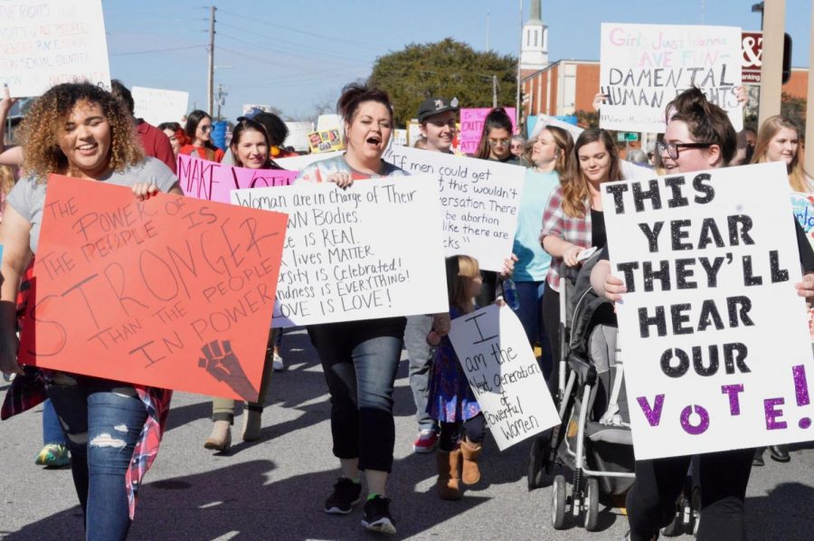 Womens March supporters walked the streets of Downtown Statesboro on Sunday. Photo by Matthew Enfinger