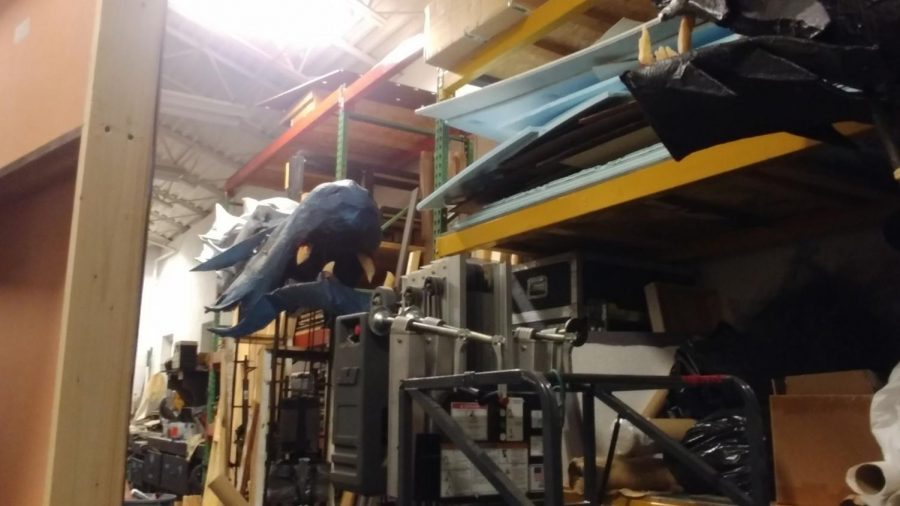 There is not a lot of walking room in the theatre department scene workshop. Only someone with years of accumulated practice could navigate their way around giant lifts, old props and slabs of lumber lying about.