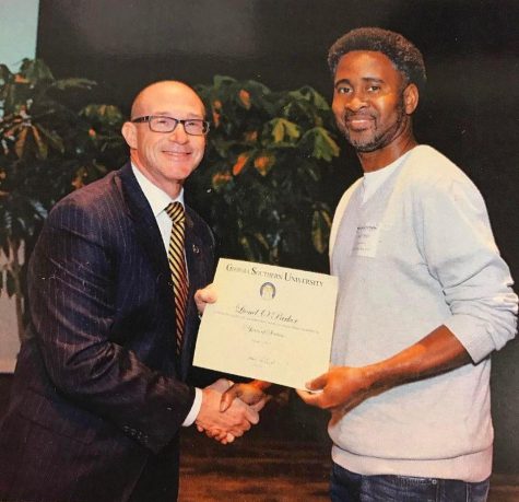 Lionel Parker (right) receives a service award from former GS President Jaimie Hebert (left). Parker received the award for ten years of service at GS.