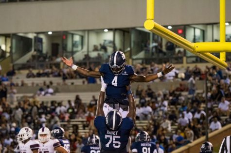 Senior center Curtis Rainey celebrates every offensive touchdown by lifting the scorer in the air. 