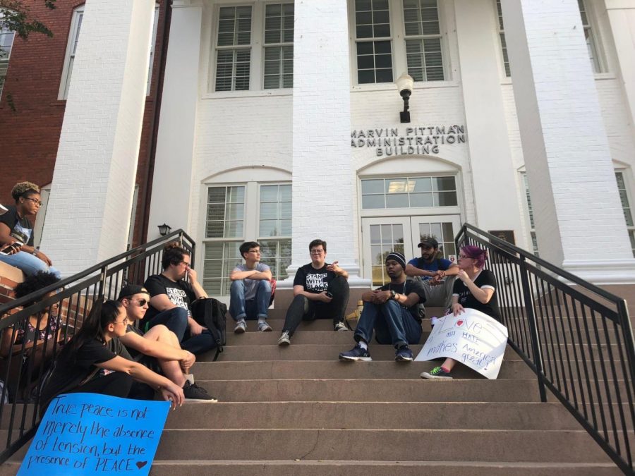 Students sit on the steps of the Marvin-Pittman Building while the march organizers meet with Nickel, Lewis and the university's lawyer. 