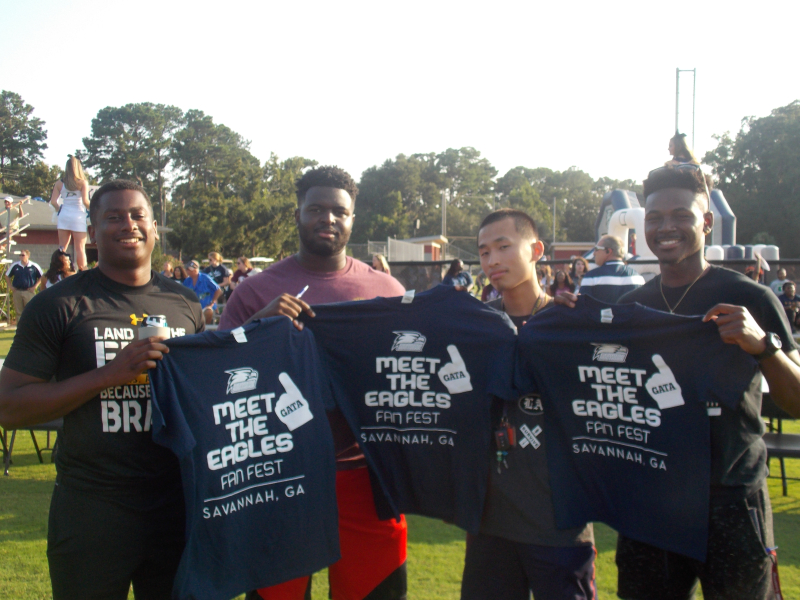 Jeremy Clark, JJ Roach, Chang Weng and Deandre Bryan with their free t-shirts from Fan Fest 2018. Photo by Ethan Smith. 