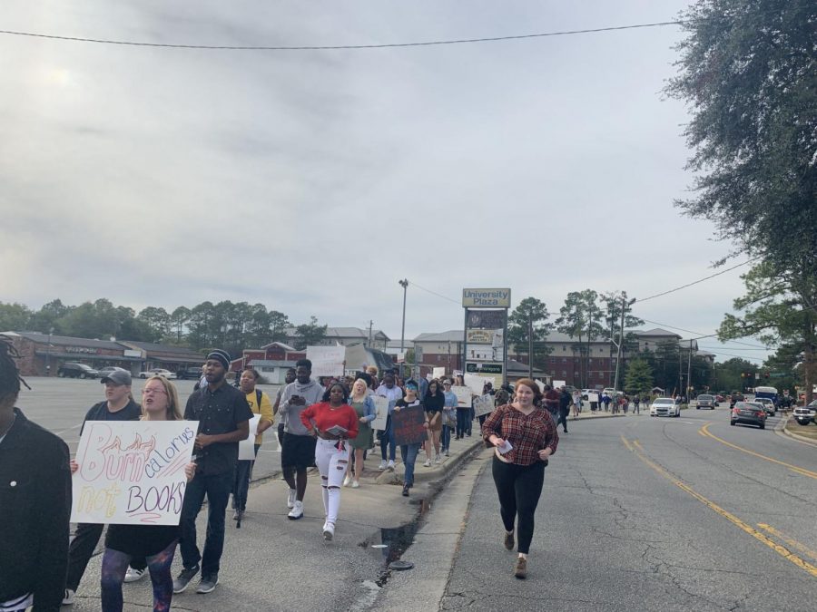Elisabeth Malloy, President of Young Democrats at Georgia Southern, walks alongside the rest of the protesters as they march to Eagle Village. 