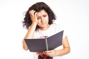 A college student is confused by her class notes taken by CollegeDegrees360, licensed under Creative Commons license 2.0