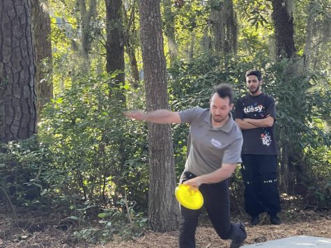Faculty head for Disc Golf Club Wes Johnson practices the inaugural throw.