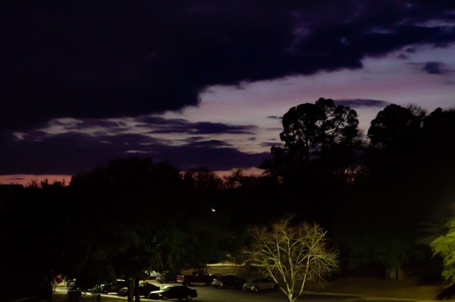 Pastel tones of orange and purple fill the Statesboro sky as the sun sinks below the tree line on February 3.