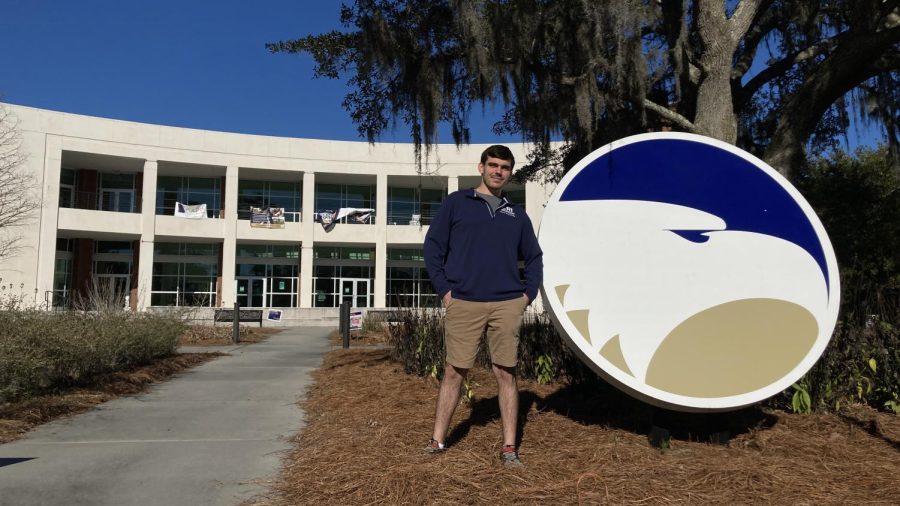 Photo of Ben posing next to the Georgia Southern logo outside of Student Union
