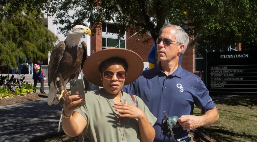 Dr.Kendra R Parker, English Department, getting cozy with Freedom. Accompanied by Steve Hein executive director of the GS Center for Wildlife Education.