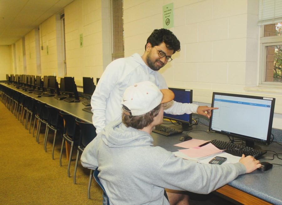 Md MahMud Hasan A GSU Graduate Student as well as Mathematics Tutor was helping Mason Todd a GSU Student in Business Administration with his Survey Of Calculus homework to help him prep for his Final  Exam  in the Master Lab 3000 Room On November 30.