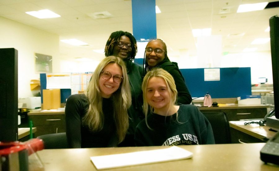 Georgia Southern Students and staff at the Printing and Postal Services, (front left) Erin Rice, (front right) Jenna Giddens, (back right) Ciersten Mckinney, (back left) Mya Rumph are excited to hand out packages at The Student Campus Mail Center in honor of celebrating National Mail Carrier Day on February 3.