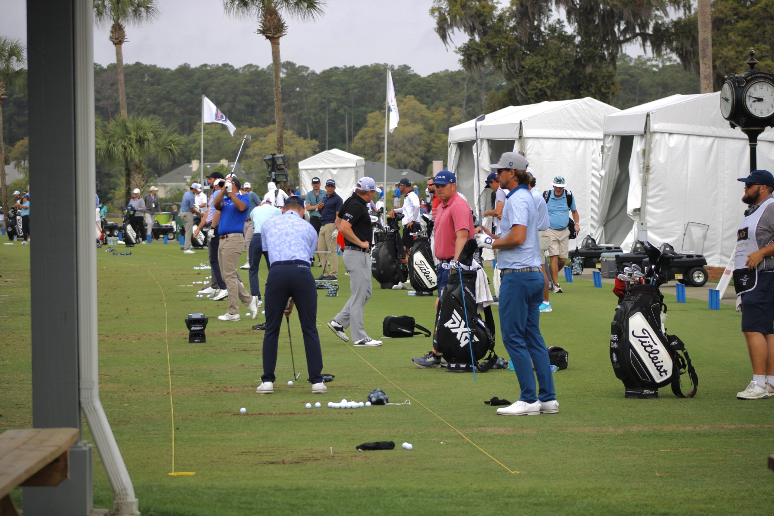 Players take practice shots before teeing off.