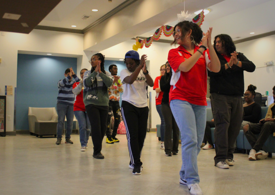 At+the+Office+of+Multicultural+Affairs+Latin+Night+event%2C+students+dance+following+the+steps+of+a+Zumba+instructor.