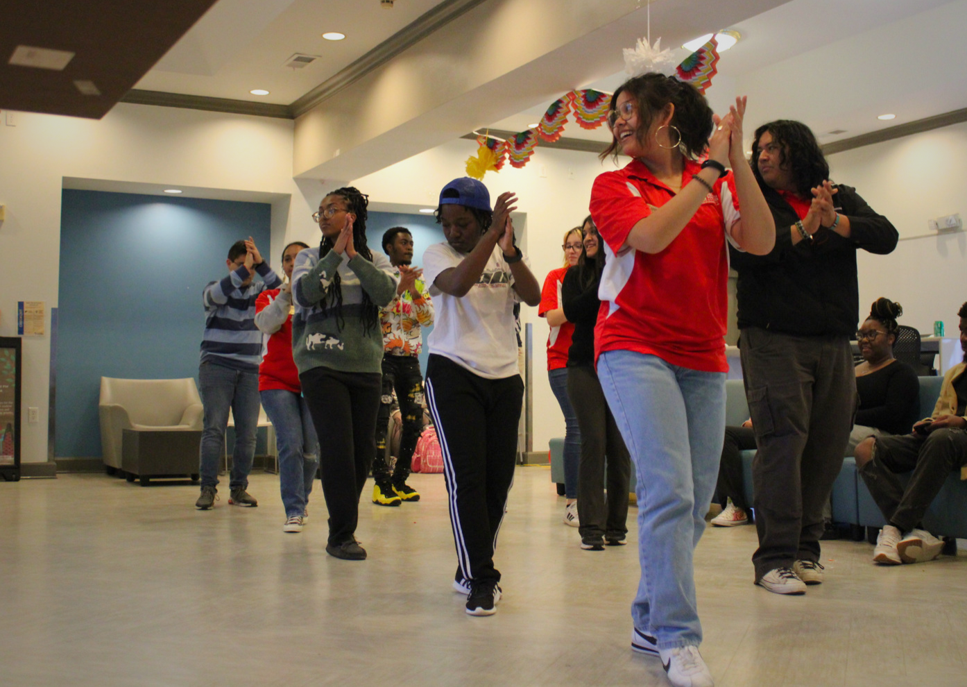At the Office of Multicultural Affairs Latin Night event, students dance following the steps of a Zumba instructor.