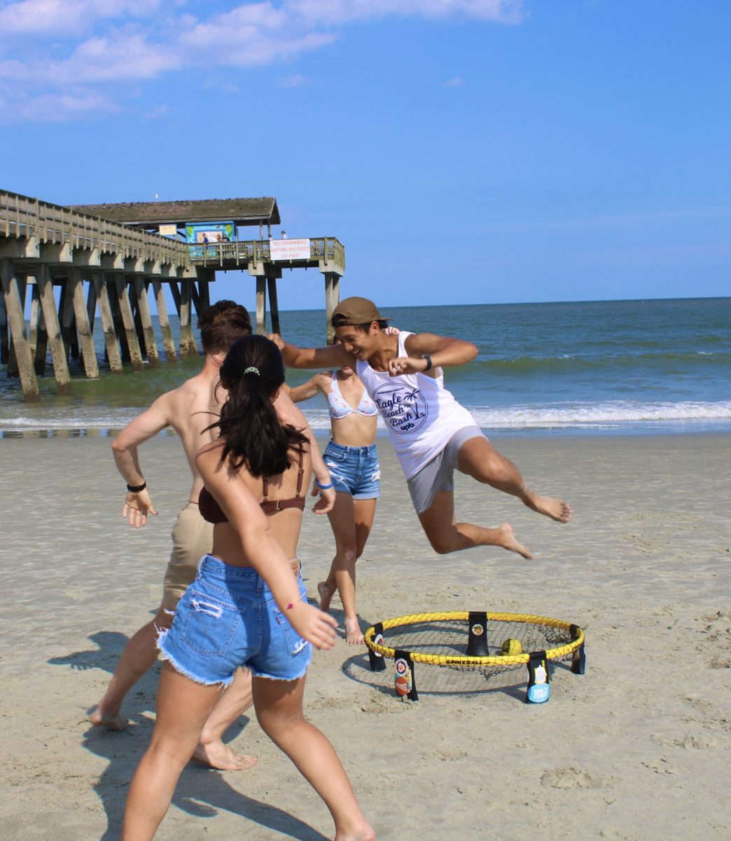 Members of Armstrongs Spikeball club enjoy a round on the beach.