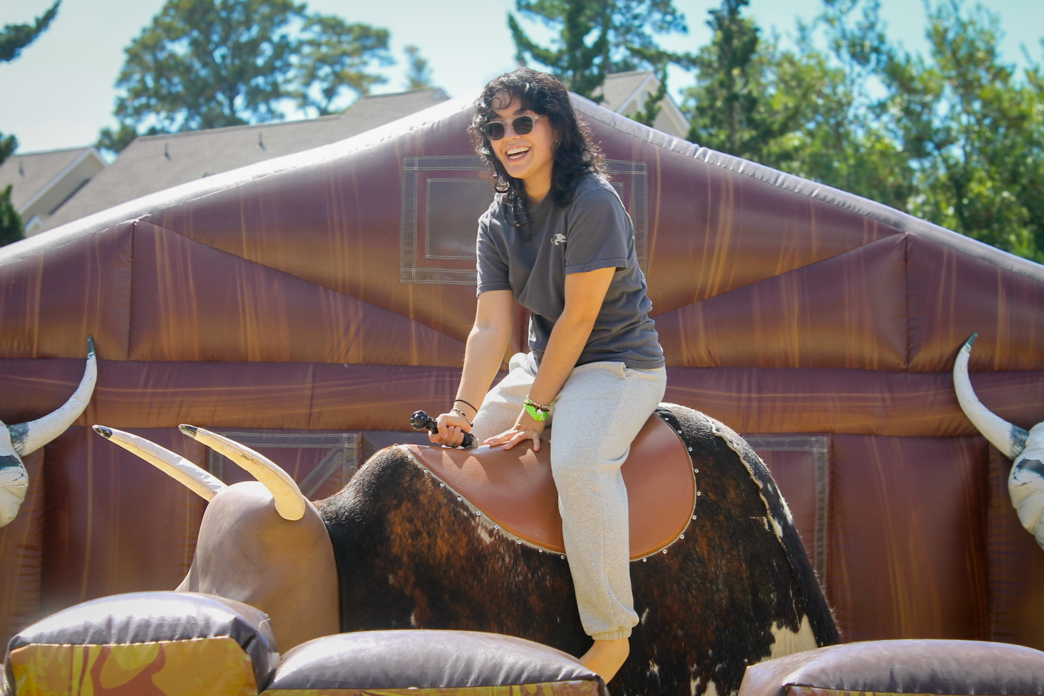 Idaly Lopez B freshman in Studio Art riding the mechanical bull
