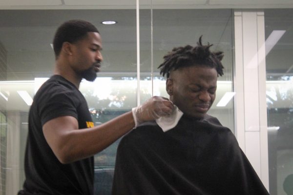 Student recoiling from rubbing alcohol applied after haircut session

Pictured: Charles Nwanna