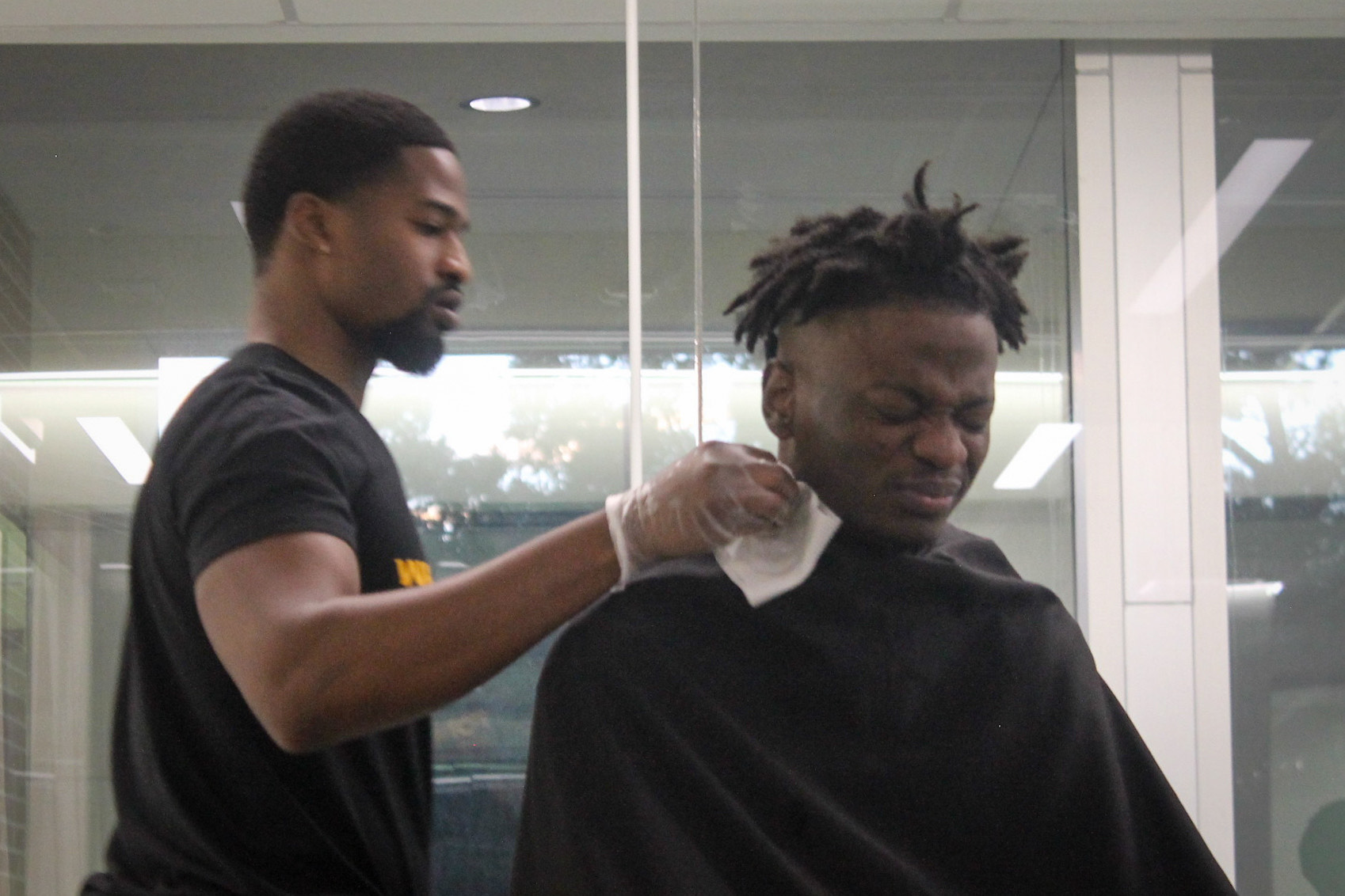 Student recoiling from rubbing alcohol applied after haircut session

Pictured: Charles Nwanna