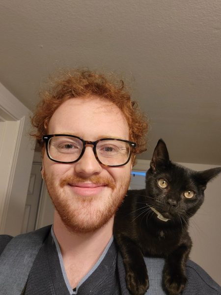 Justin Andrews with his cat, Taco Bell