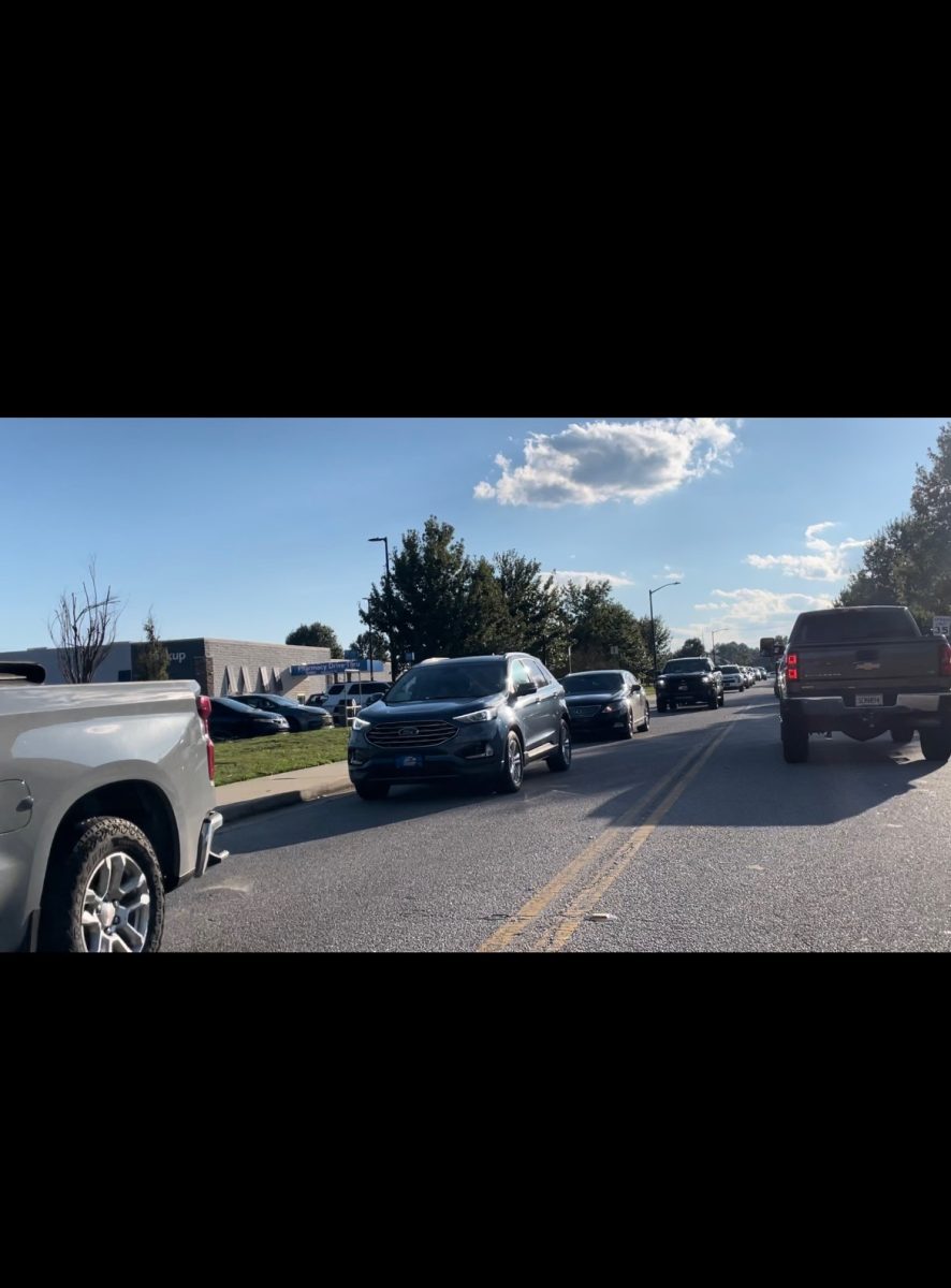 A line of cars waiting to get gas at the Walmart Neighborhood Market