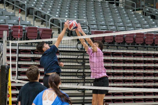 Riley Upton (Team Raw Sets) blocking the spike delivered from Connor Martinez (Team Set Tile Dysfunction)