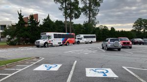 Two intercampus shuttle buses line up on the Armstrong campus. 